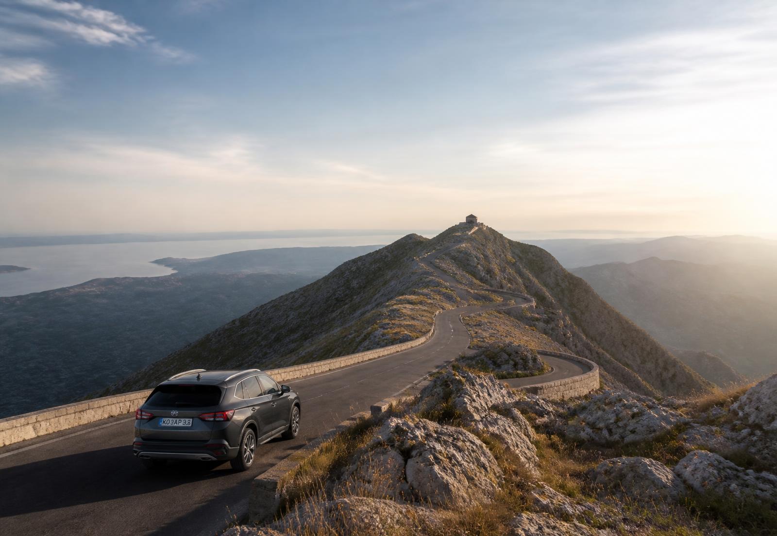 Modern SUV on the winding mountain road climbing towards Lovćen, Montenegro